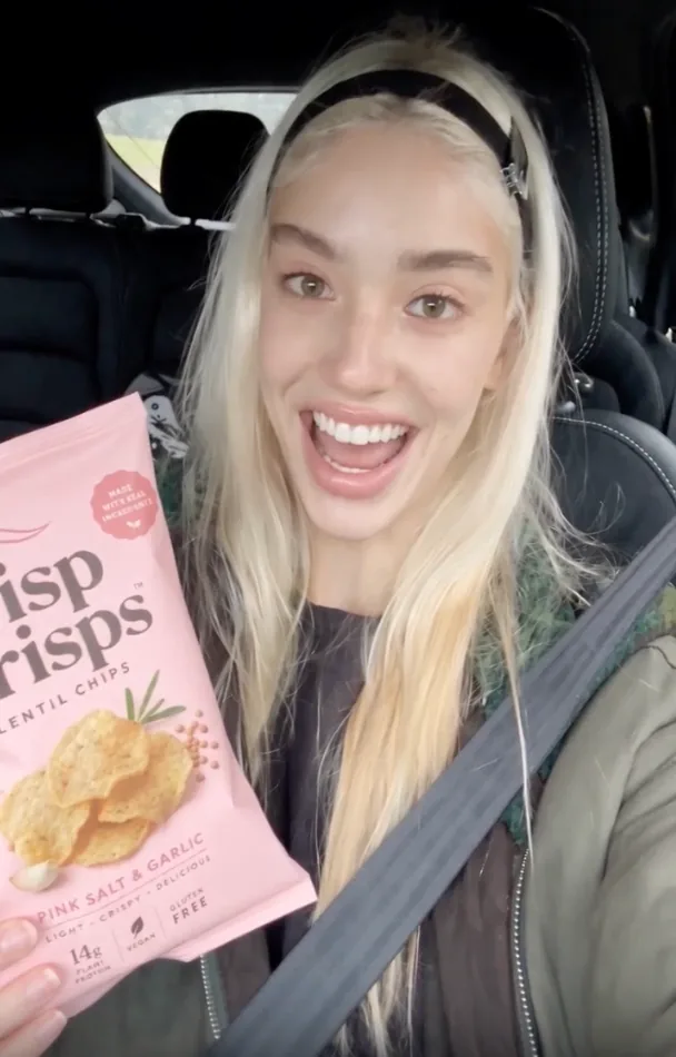 Reference image of a creator reviewing snacks in a car